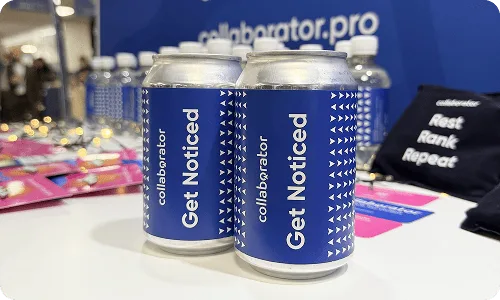 Puszki z logo Collaborator wyeksponowane na stoisku podczas BrightonSEO 2025.