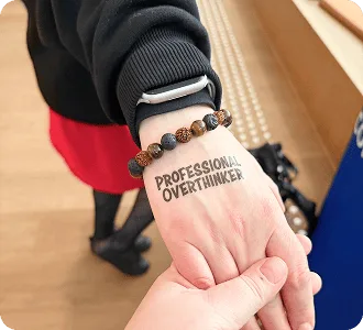 Tymczasowy tatuaż „Professional Overthinker” na dłoni uczestnika Baltic-Nordic SEO Summit 2026.